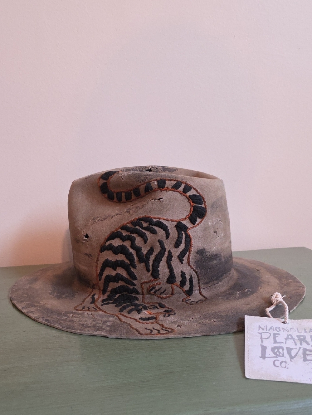 Magnolia Pearl Distressed Tan Suede Fedora with Embroidered Black Tiger